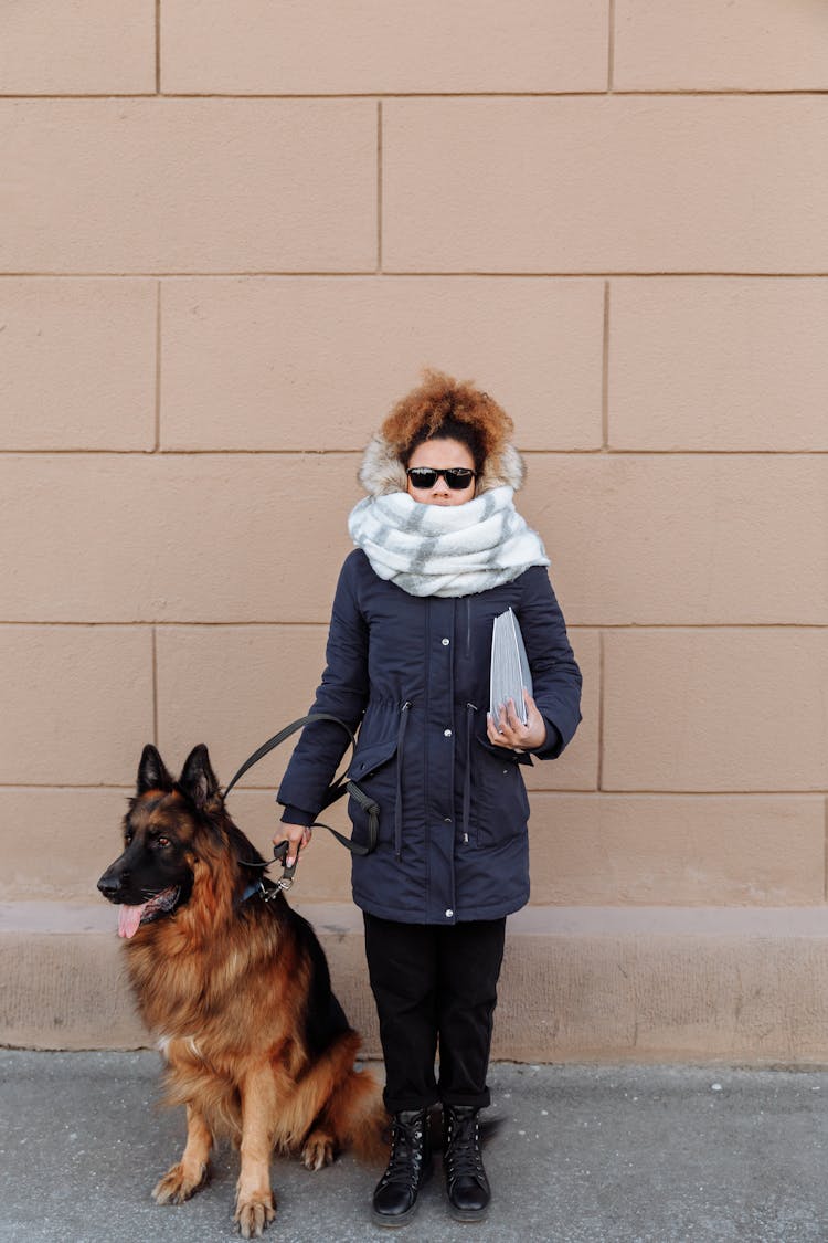 A Blind Woman Standing With Her Dog