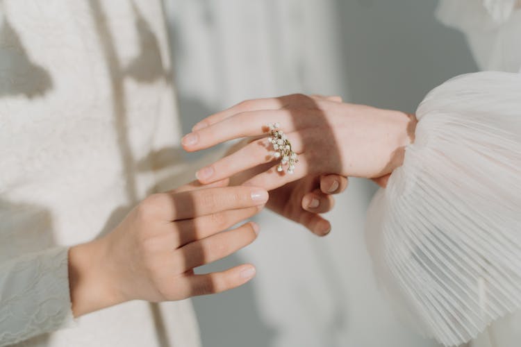 Woman In White Wedding Dress Wearing A Ring