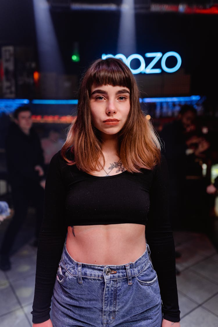 Shallow Focus Of A Woman Wearing Black Long Sleeve Crop Top