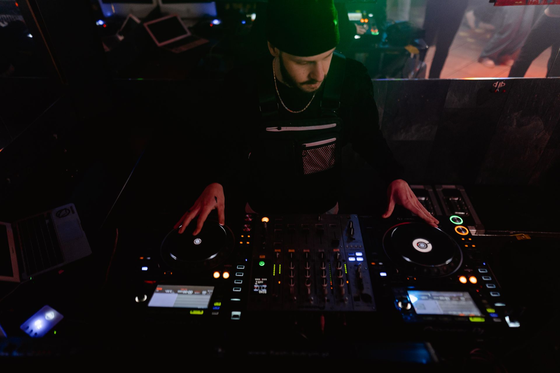 DJ performing at a nightclub, engaging the crowd with dynamic music mixes.