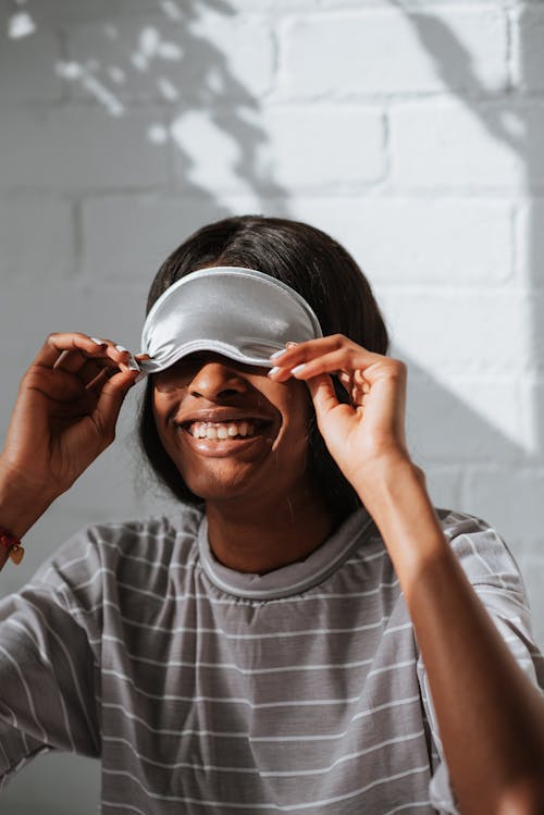 Woman Taking a Sleeping Mask Off and Smiling 