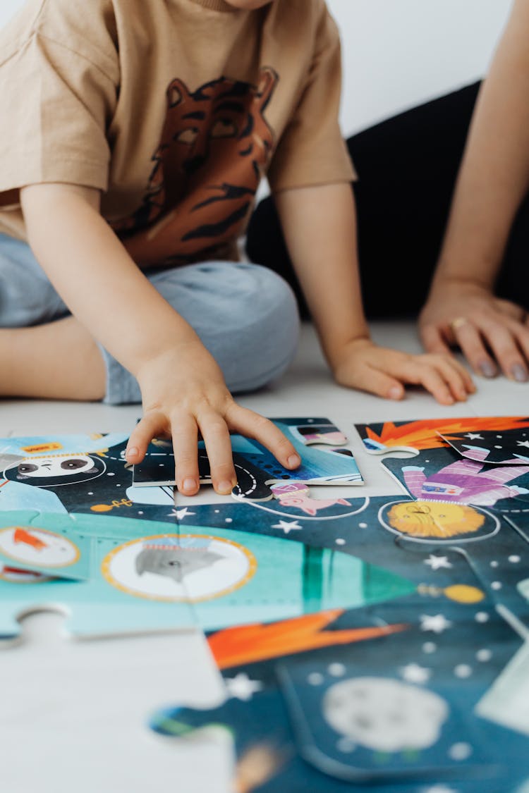 Close-up Of Mother And Her Son Doing Puzzles 