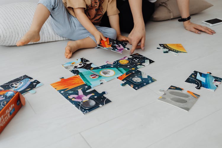 Child Doing Puzzle With Parent