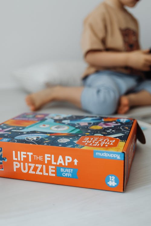 An Orange Jigsaw Puzzle Box in Close-Up Photography