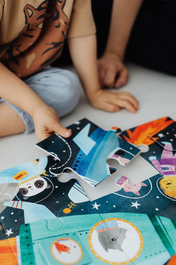 Photograph Of A Child Solving A Jigsaw Puzzle