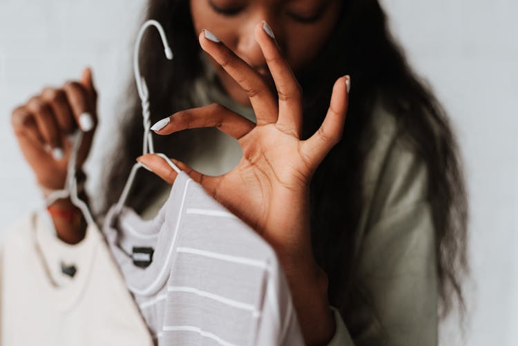 Crop Black Woman With Clothes Showing Okay Gesture