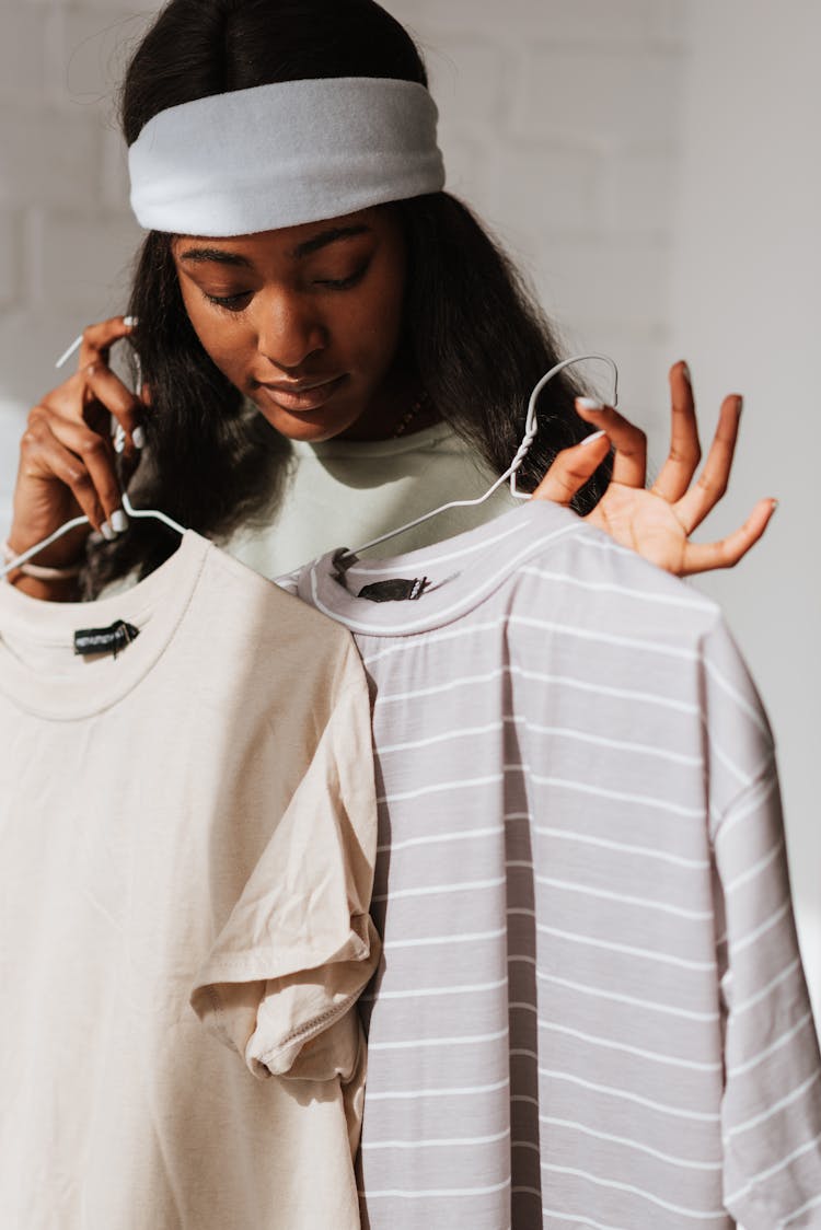 Black Woman Choosing Wear While Showing Good Gesture In Sunshine