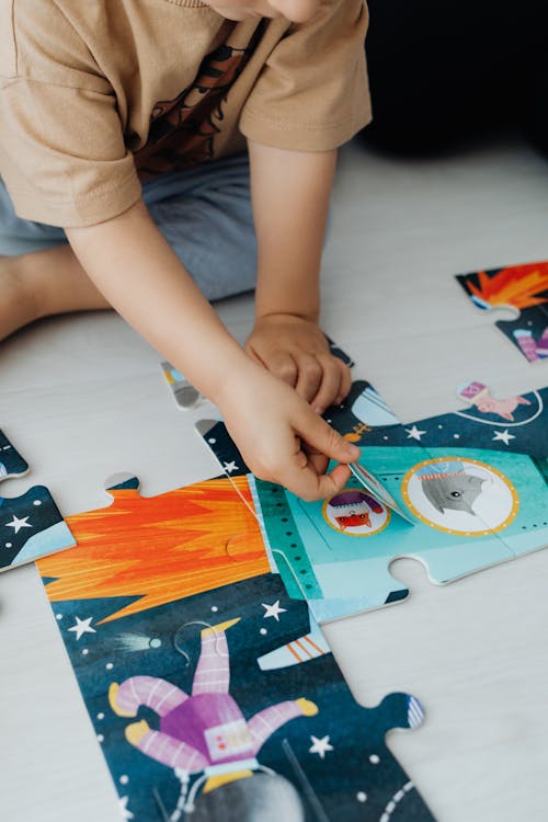 Close-up of Child Connecting Puzzle