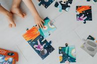 Person Holding Blue Green and Orange Puzzle Piece