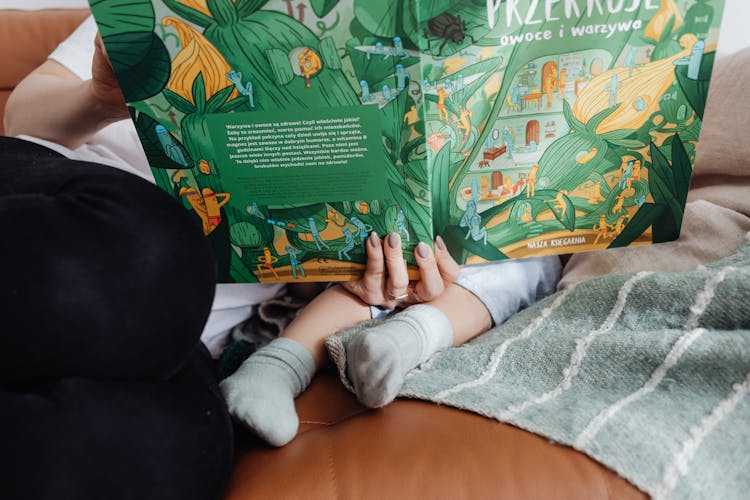 Mother Holding Book With Child