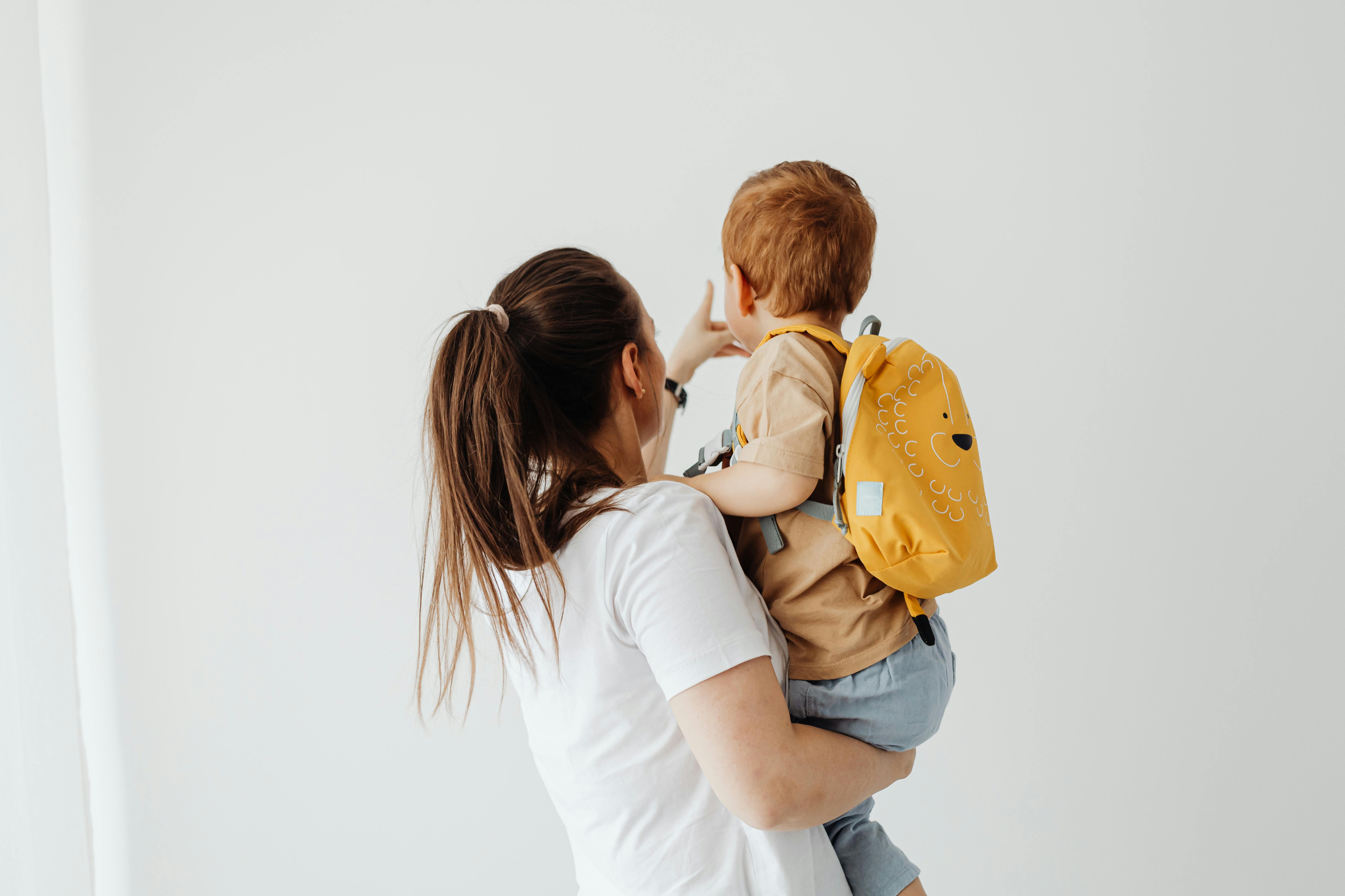 back view of a woman holding a boy