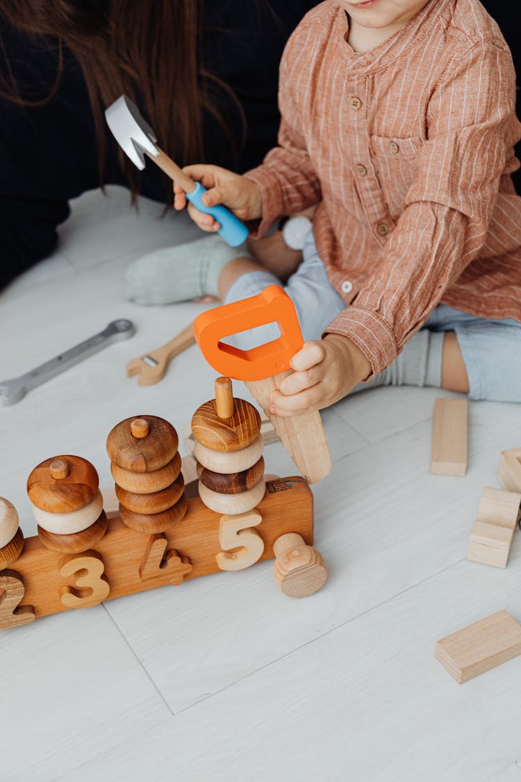 Child Holding Wooden Tool Toys Playing