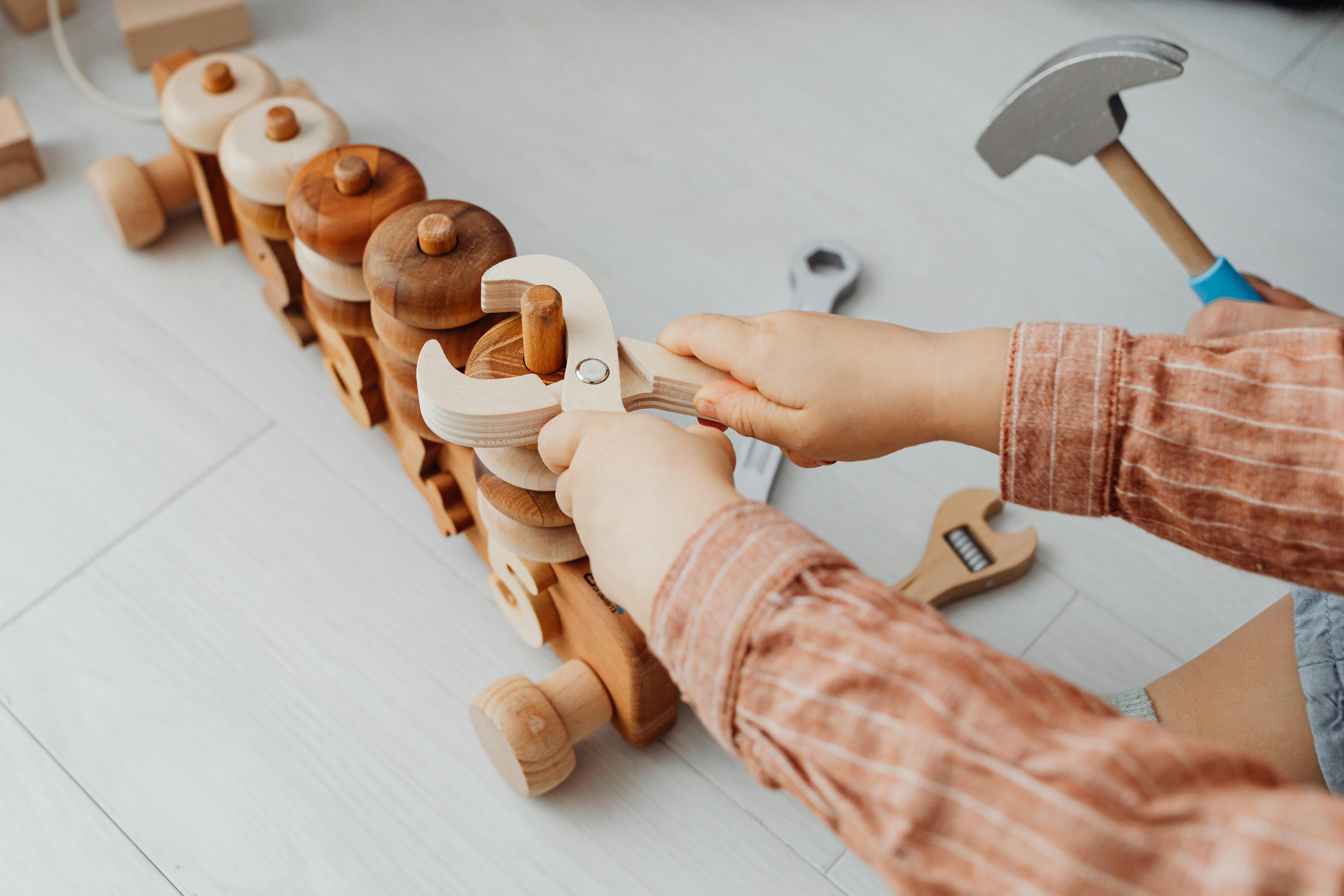 a kid playing with wooden toys