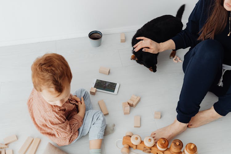 Overhead Shot Of A Boy Sitting Near Wooden Toys