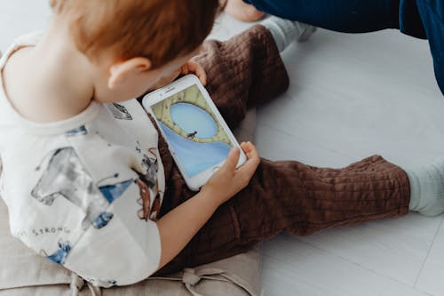 Little Child Playing Game on Mobile Phone