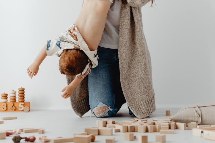 Woman Holding Her Son Upside Down