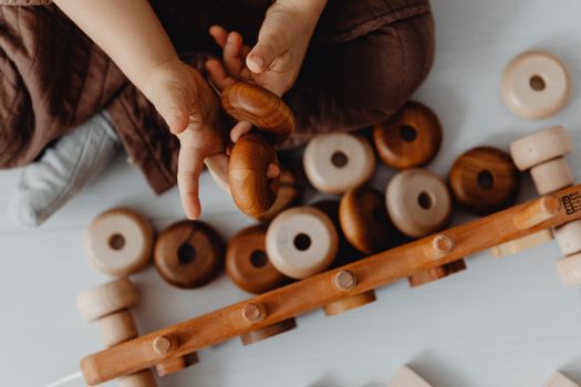 Hands of Child Playing with Wooden Toys