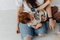 Photo of a Kid with Red Hair on a Person's Lap