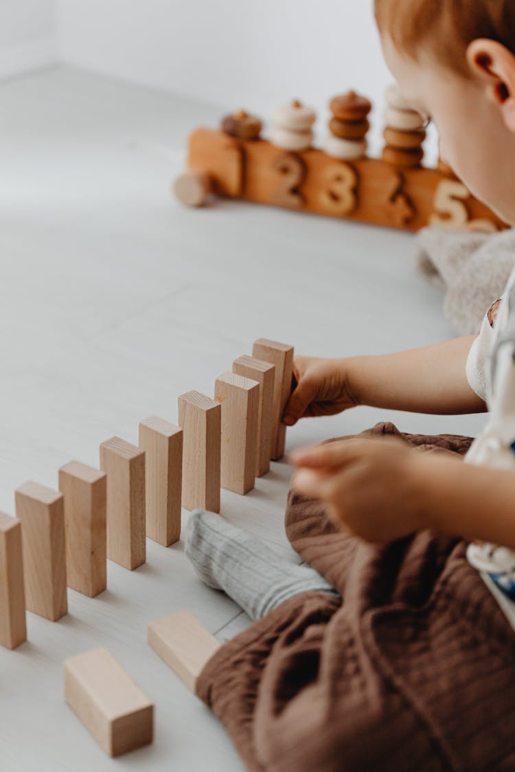 Boy Playing With Wooden Toy Blocks