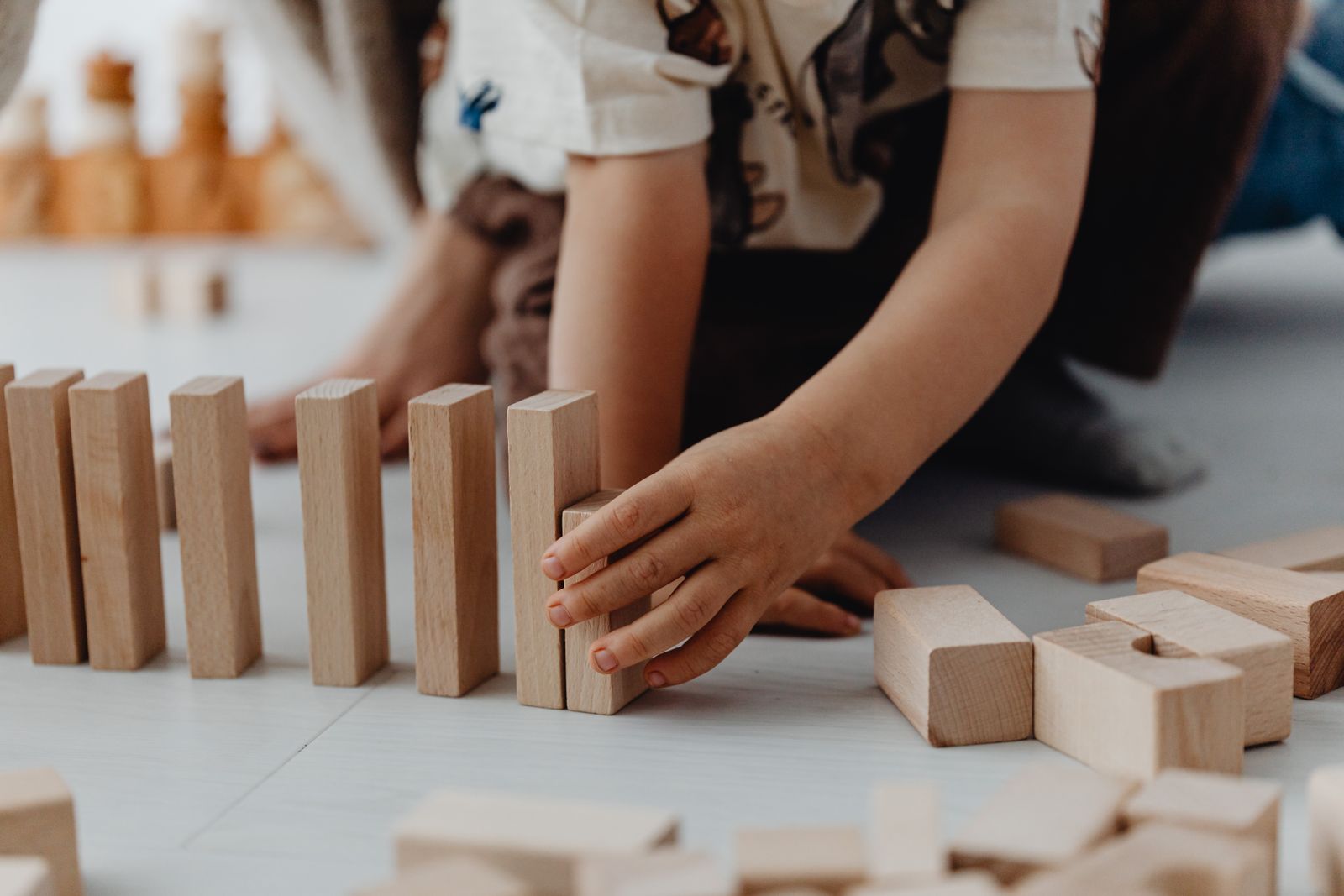 Child enjoying focused play with colorful wooden learning toys
