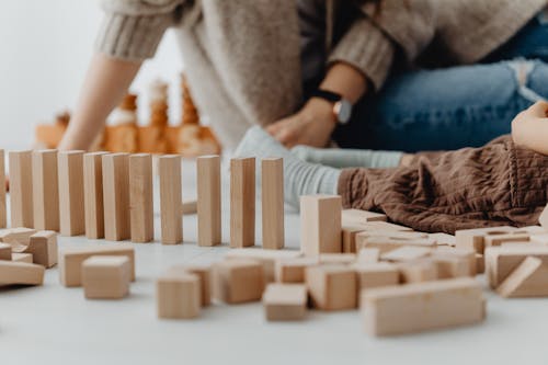 Photo of Wooden Blocks Near a Child's Legs