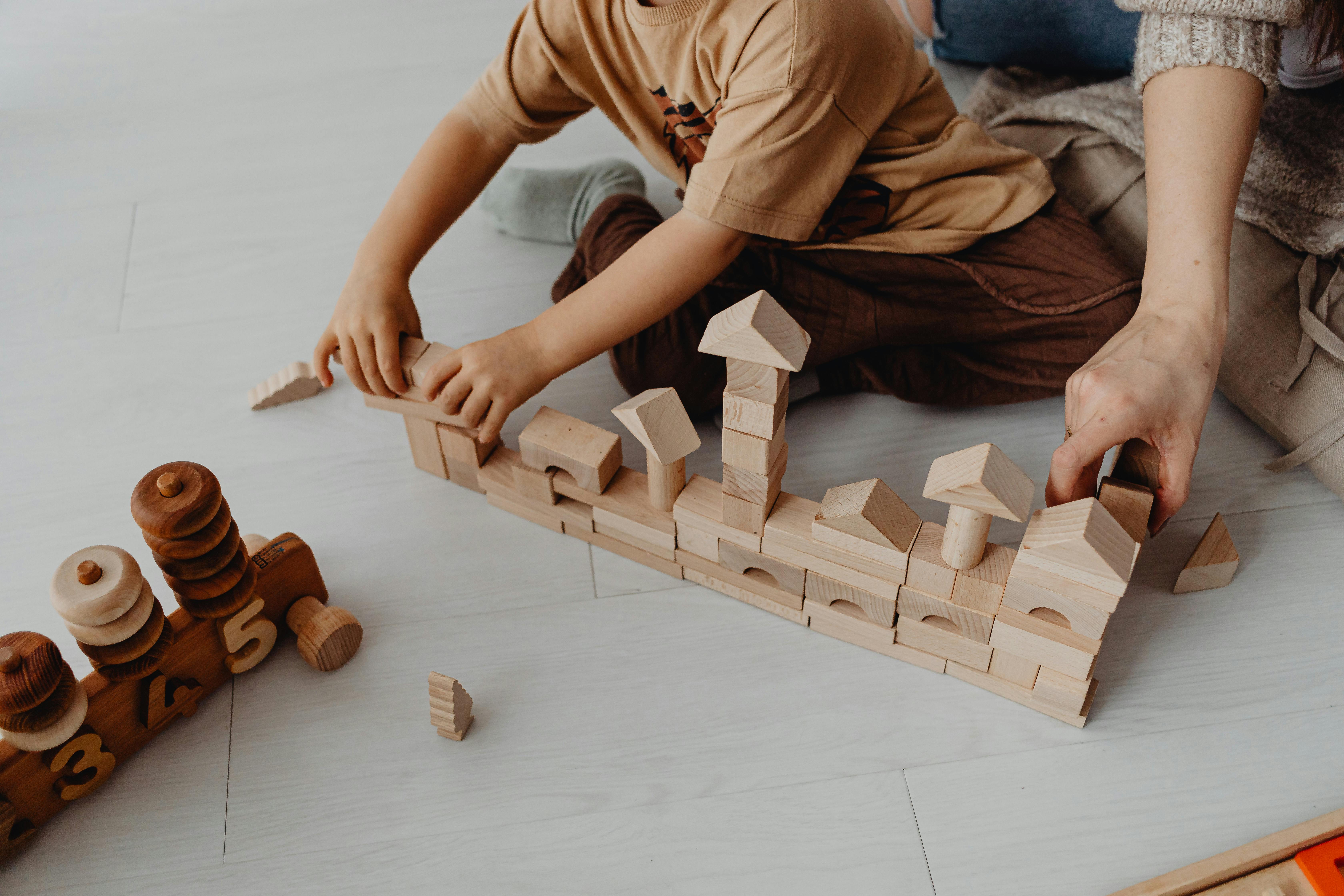 boy building with toy blocks