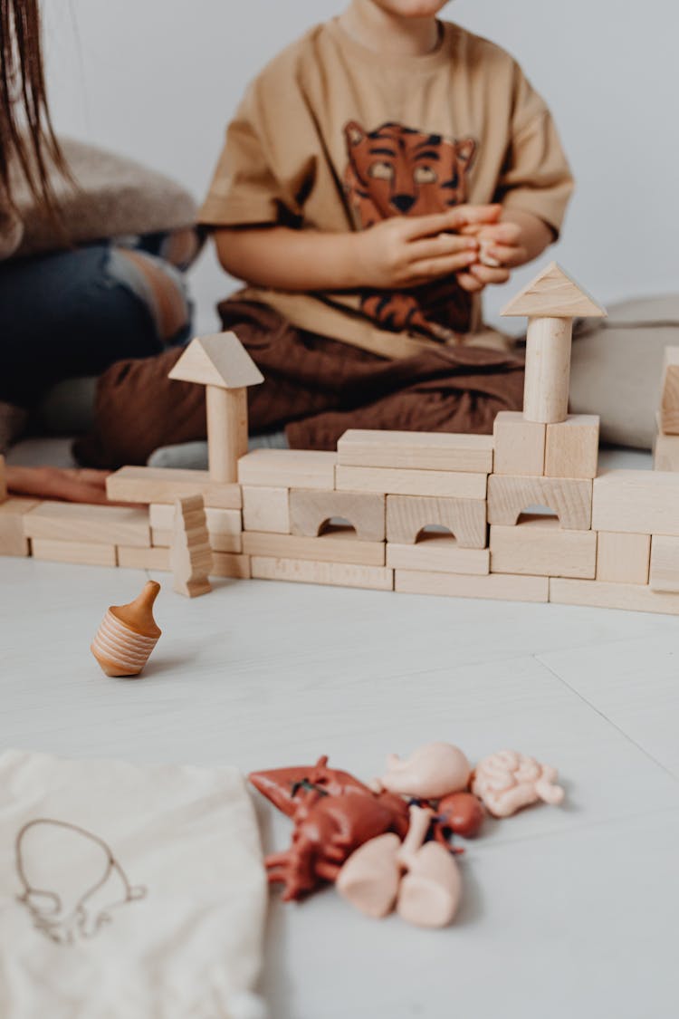 Child Sitting With Toy Blocks