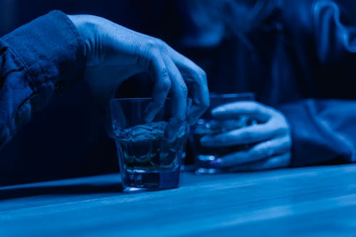 Photo of a Person's Hand Holding an Alcoholic Drink