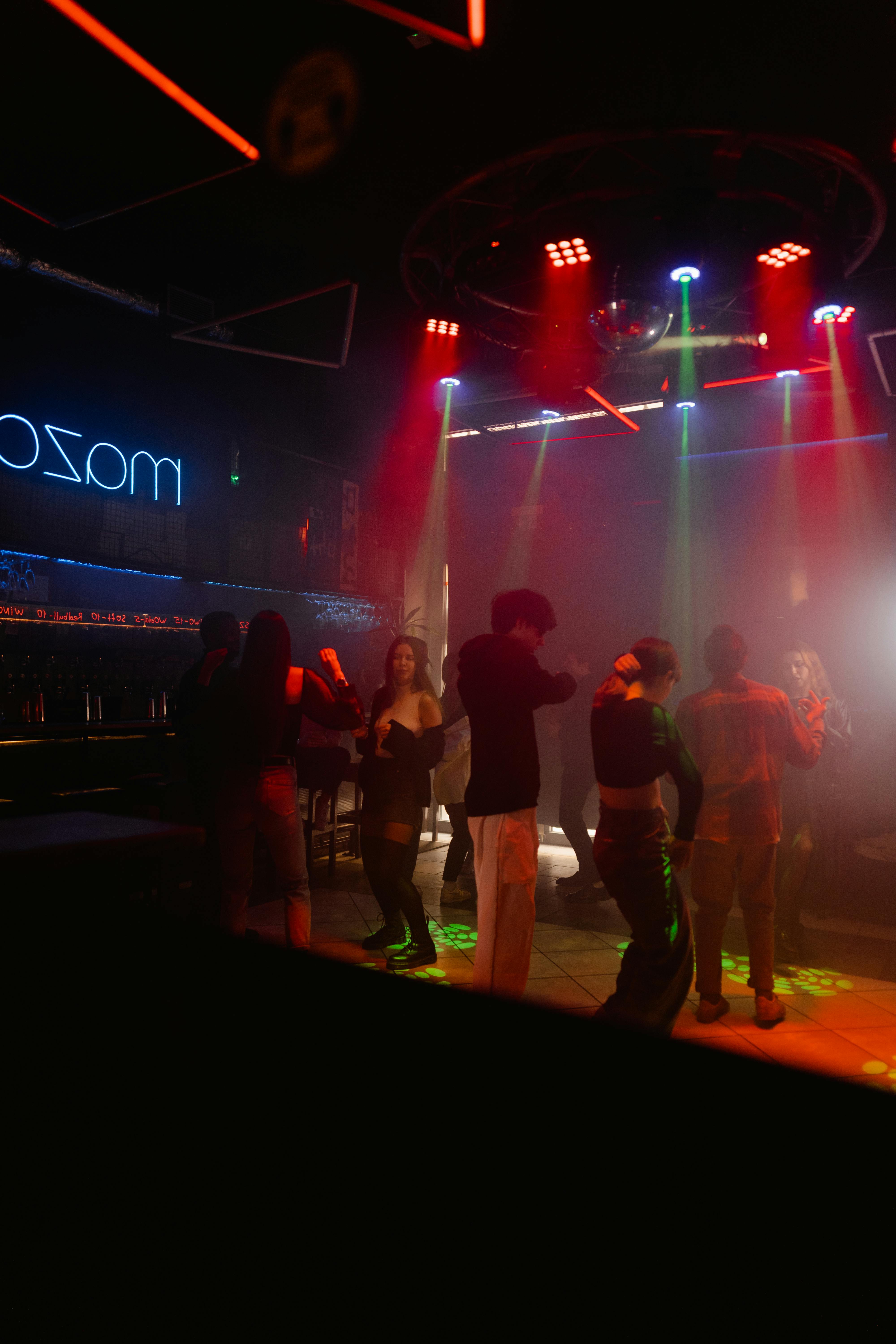 people standing on stage with red lights