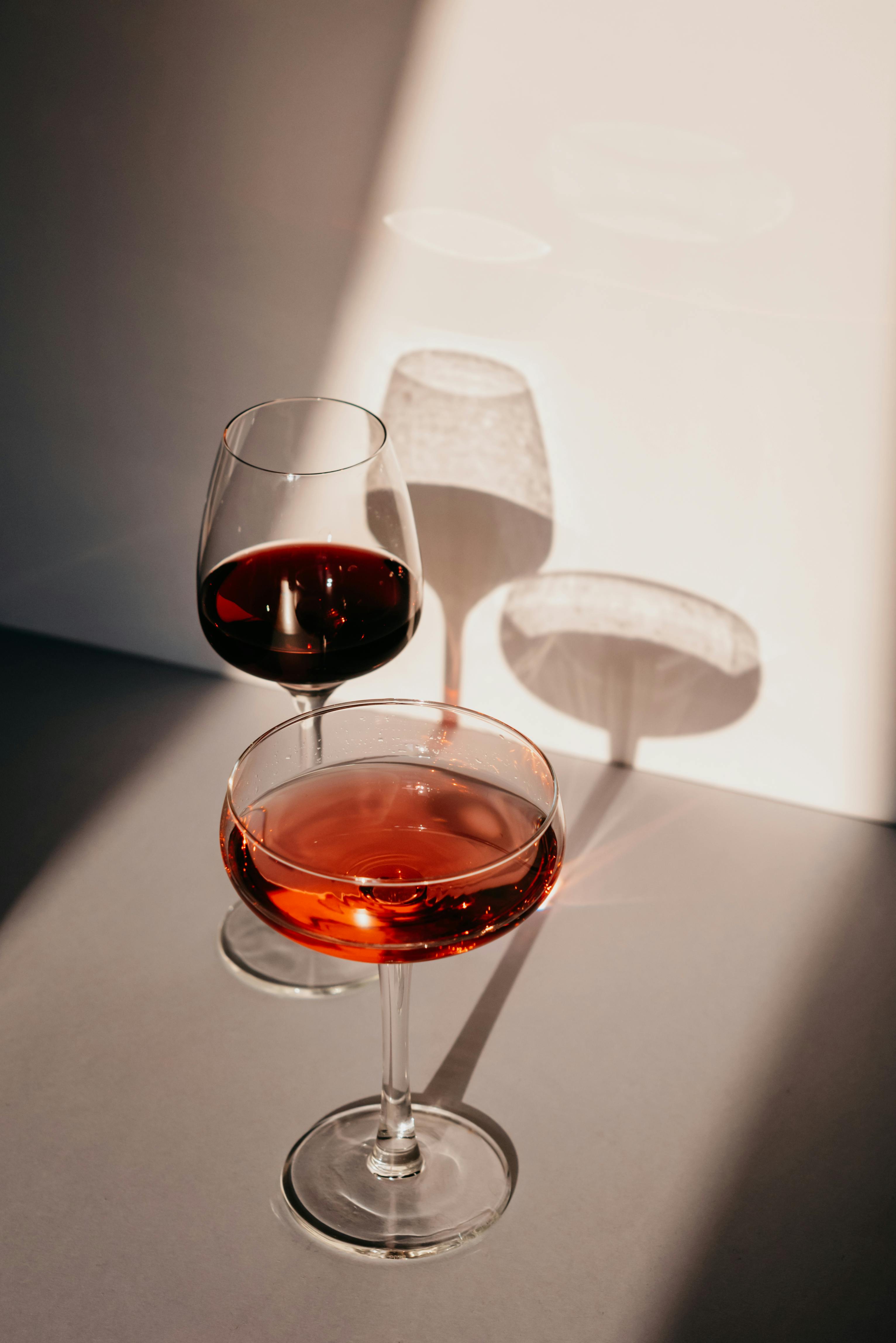 Glass Of Cheap Red Wine With A Drinking Straw On A Reflective Silver Table  With White Background. Stock Photo, Picture and Royalty Free Image. Image  5436658.