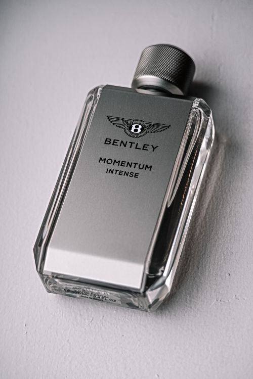Free Elegant Bentley Momentum Intense perfume bottle captured in a sleek product shot. Stock Photo