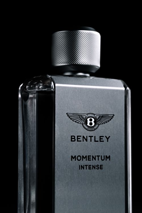 Free Close-up of a Bentley Momentum Intense perfume bottle showcasing its luxury design and brand presence. Stock Photo