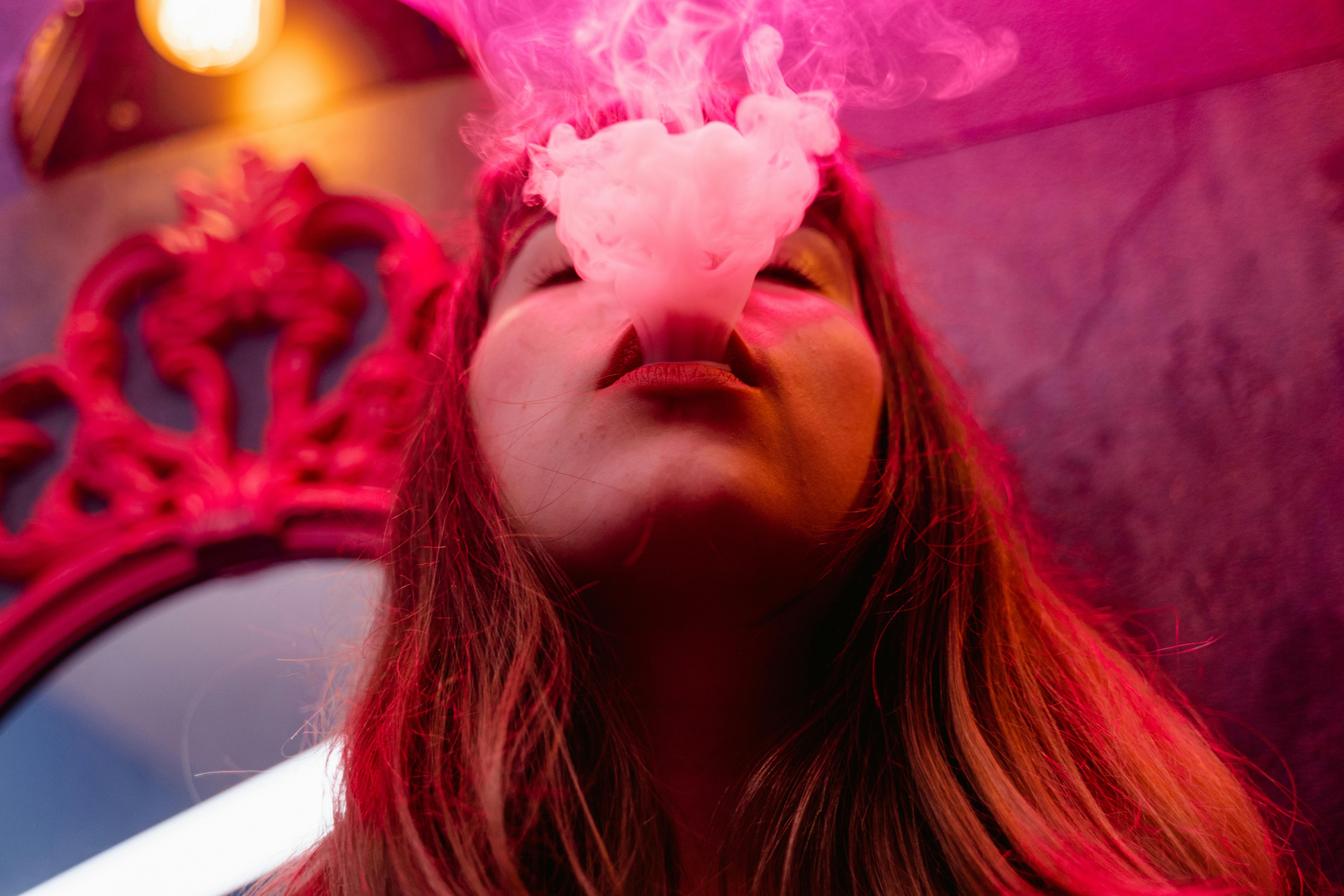 close up photograph of a woman smoking