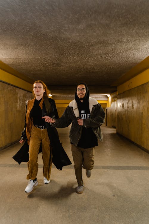 Man and Woman Running in a Tunnel