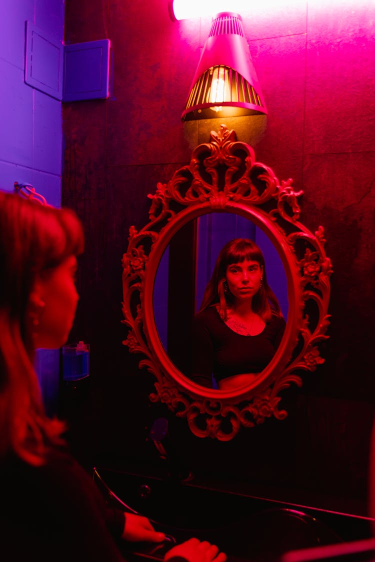 Woman Standing In Front Of A Mirror