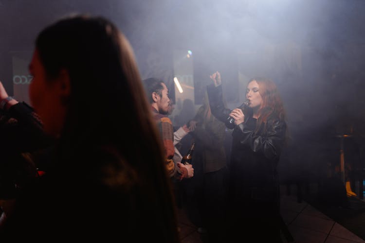 Crowd Drinking Beer Inside A Smokey Room