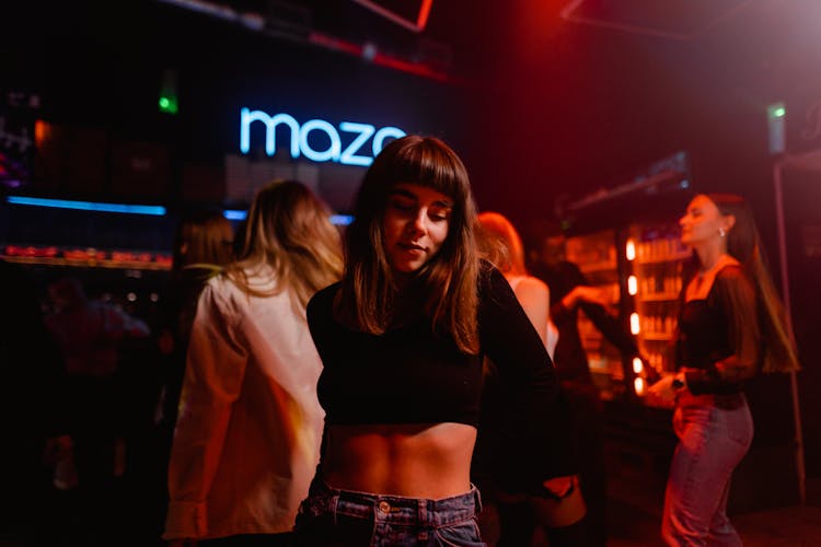 A Woman In Black Crop Top Looking Down