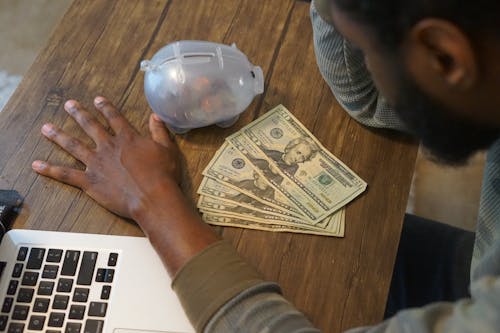 Free stock photo of african american man, black man with money, desk Stock Photo