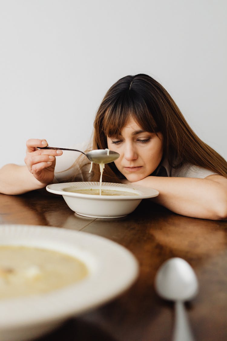 Sad Woman Eating Soup