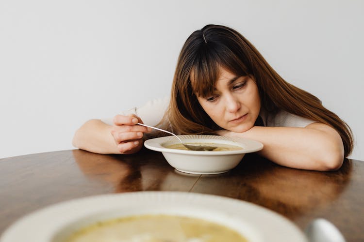 Bored Woman Eating Soup