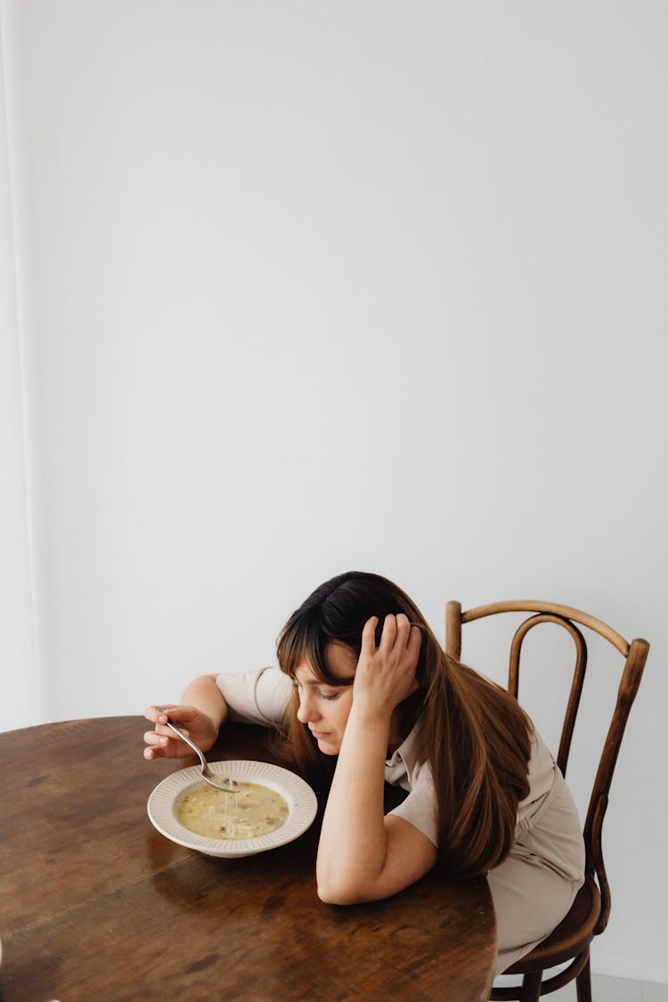 Woman Eating Soup