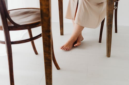 Free Female Feet under Table Stock Photo