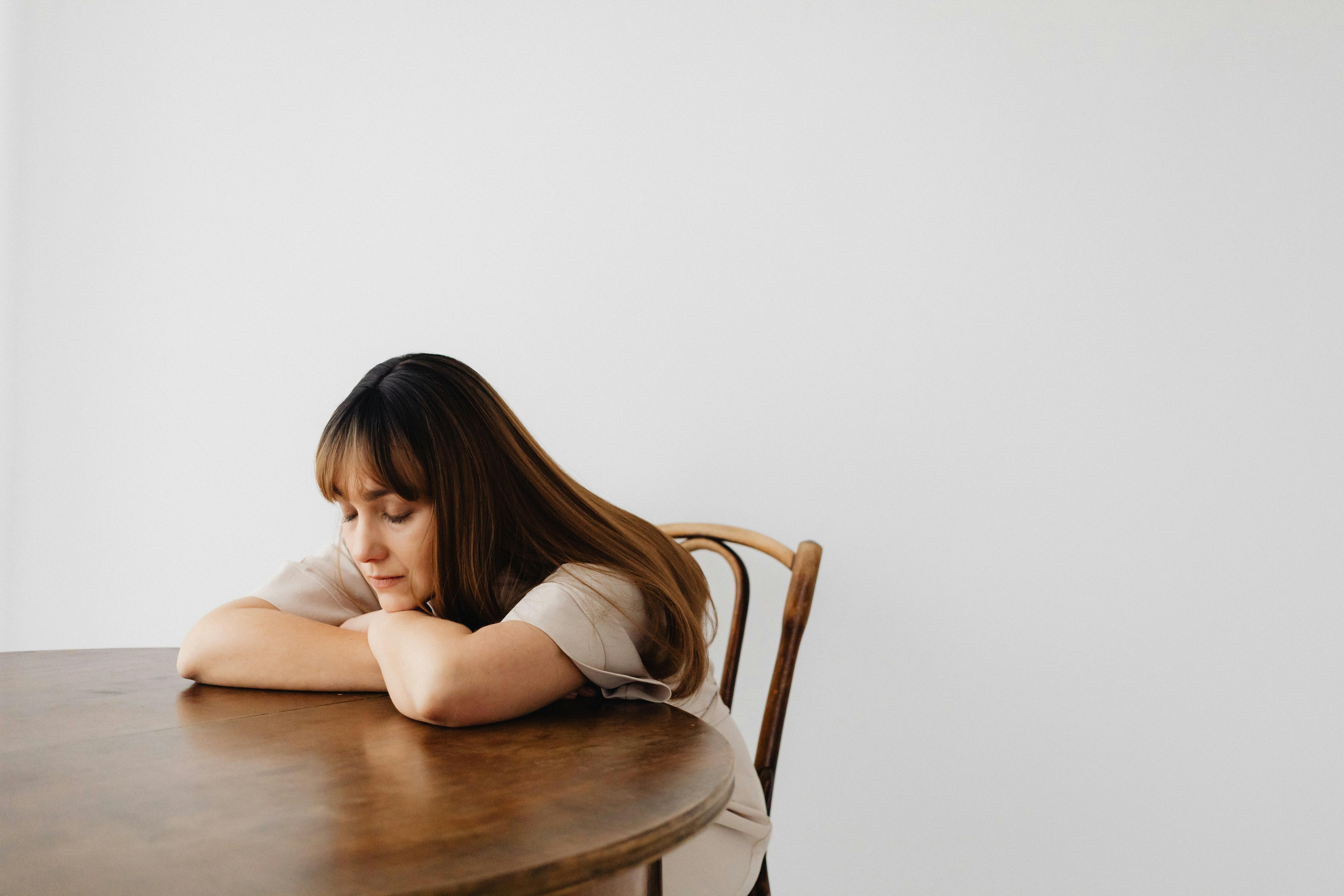 Portrait of a Woman Sitting at a Table