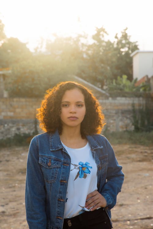 A Woman in Denim Jacket Looking with Her Hand on Her Waist