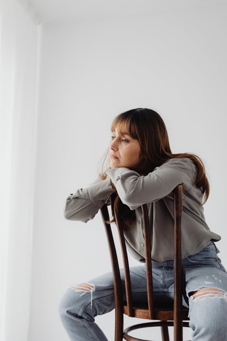 Sad Woman Sitting On A Chair