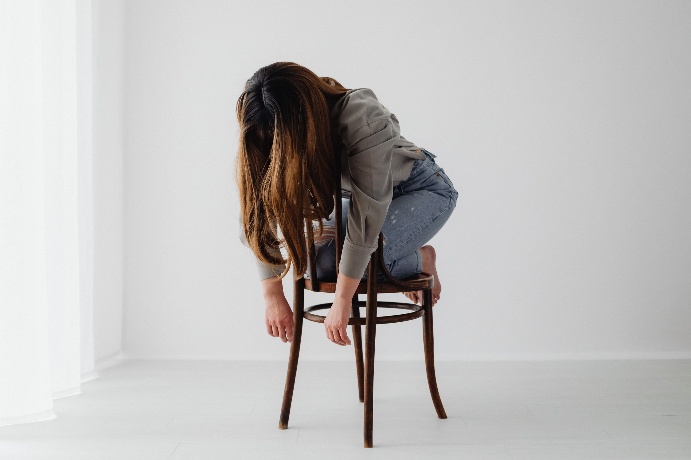 Woman Sitting on a Chair Backwards in a Slouchy Way · Free Stock Photo
