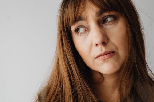Free Close-up portrait of a thoughtful adult Caucasian woman looking away. Stock Photo