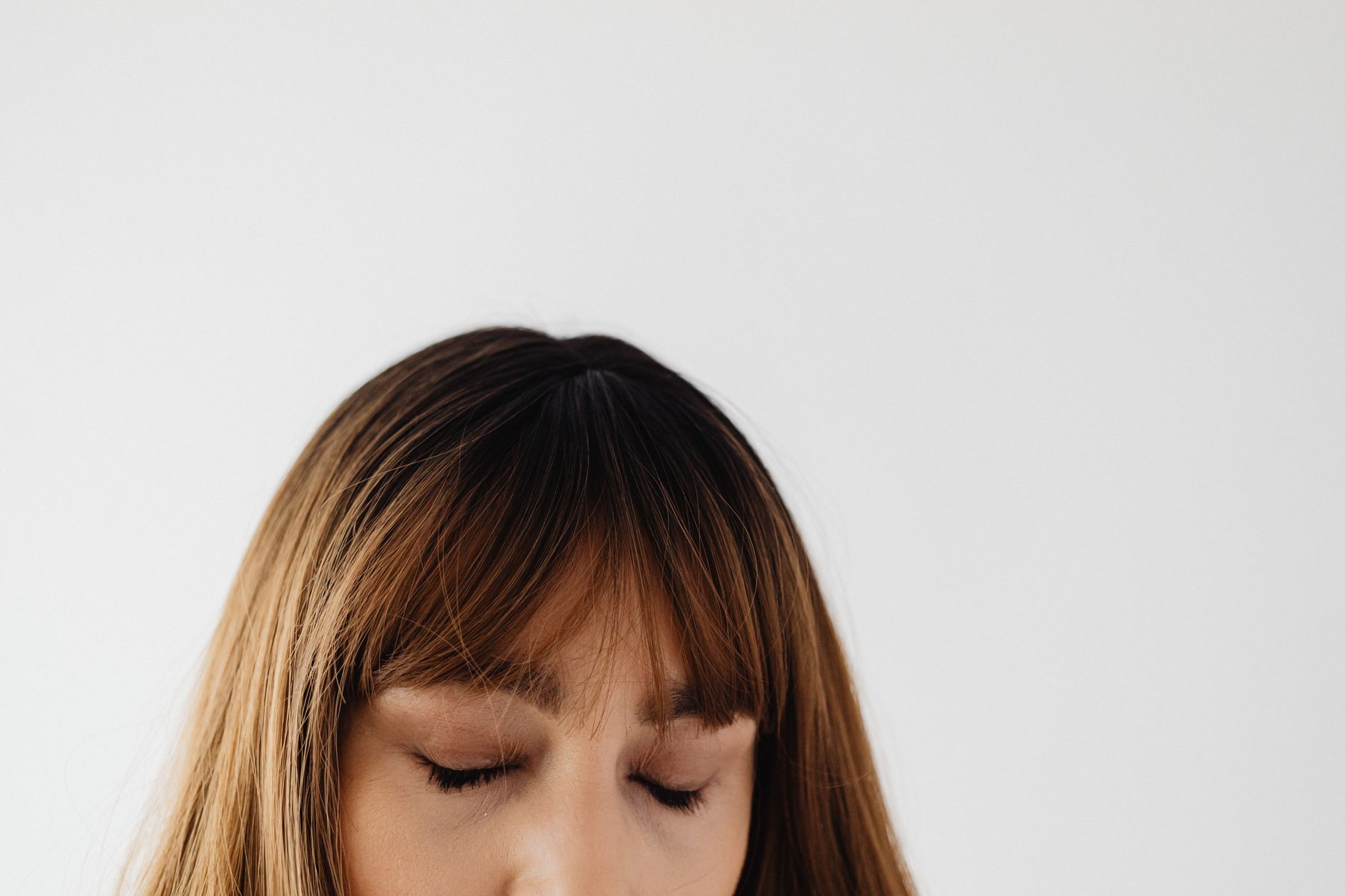 Close-up portrait of a woman with closed eyes and brunette hair, exuding calmness and serenity.