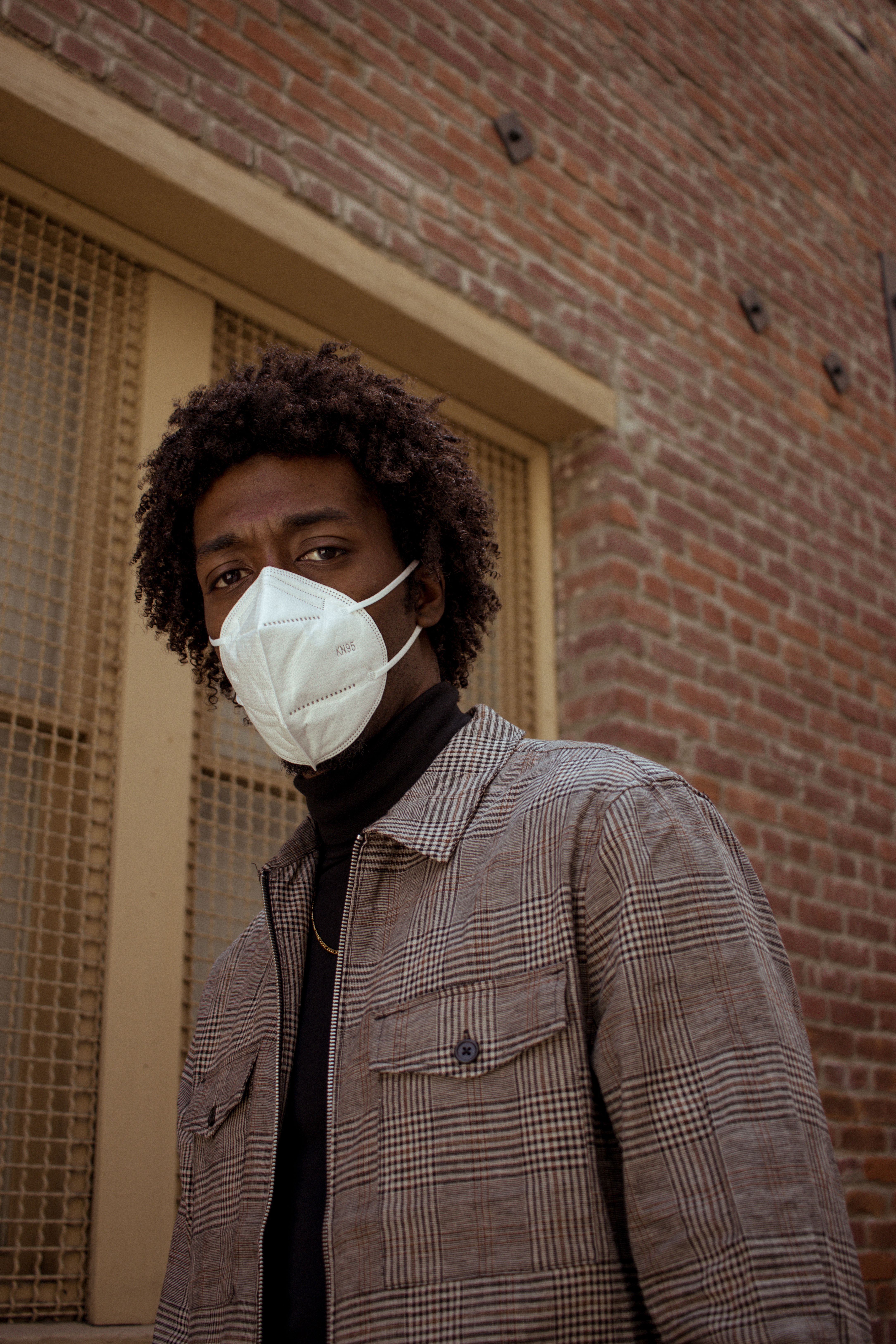 A Man Wearing a White Face Mask Looking at Camera · Free Stock Photo