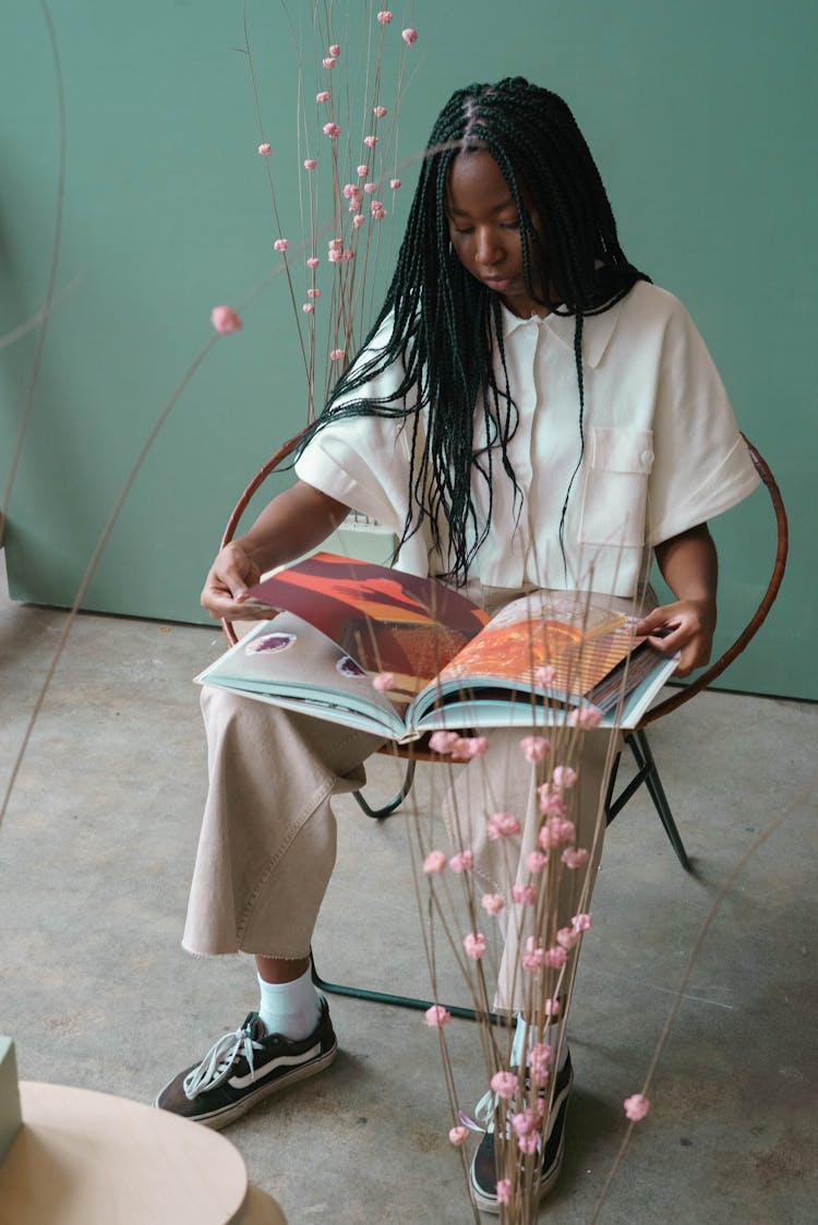 Trendy Black Woman With Book Between Flower Sprigs